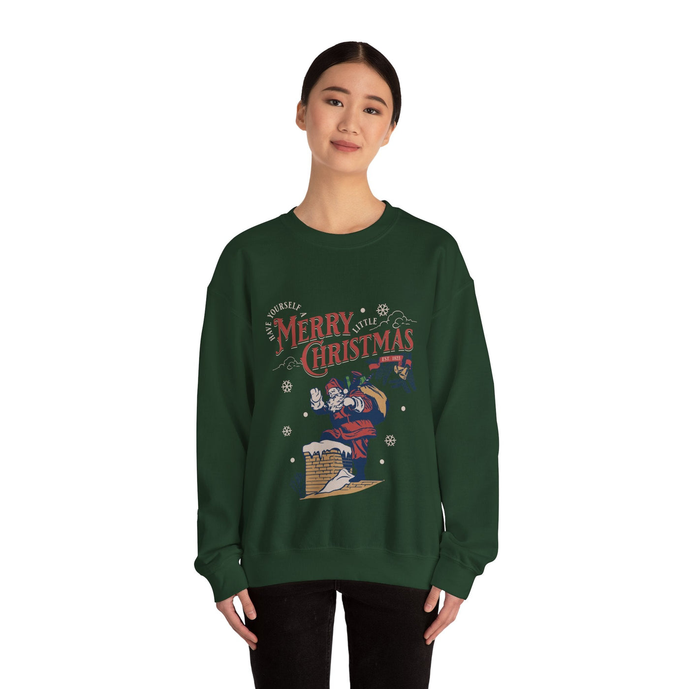 Woman wearing dark green Vintage Santa Crewneck sweatshirt with Santa carrying gift bag into chimney and Merry Christmas text