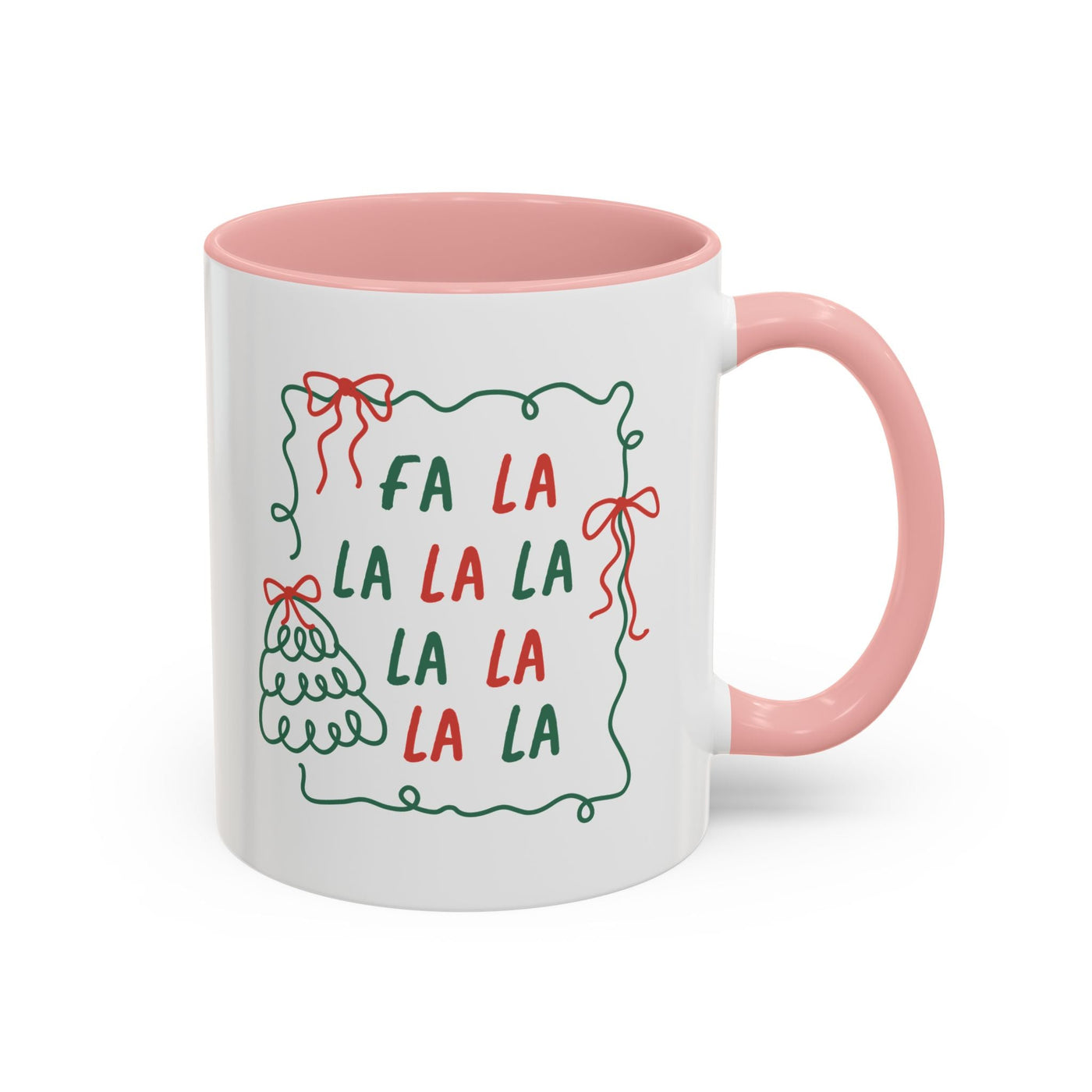White ceramic Fa La La Christmas coffee mug with pink handle and interior, minimalist holiday design with red and green text and bows