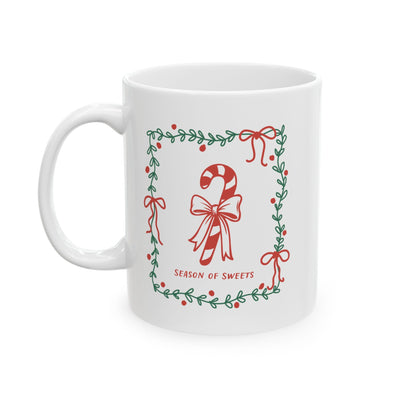 White ceramic mug with green border and candy cane "Season of Sweets" design, available in 11oz and 15oz sizes