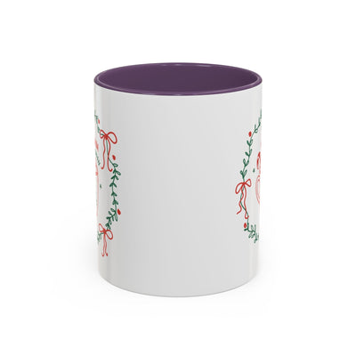 White ceramic mug with red interior and festive greenery design for hot cocoa season