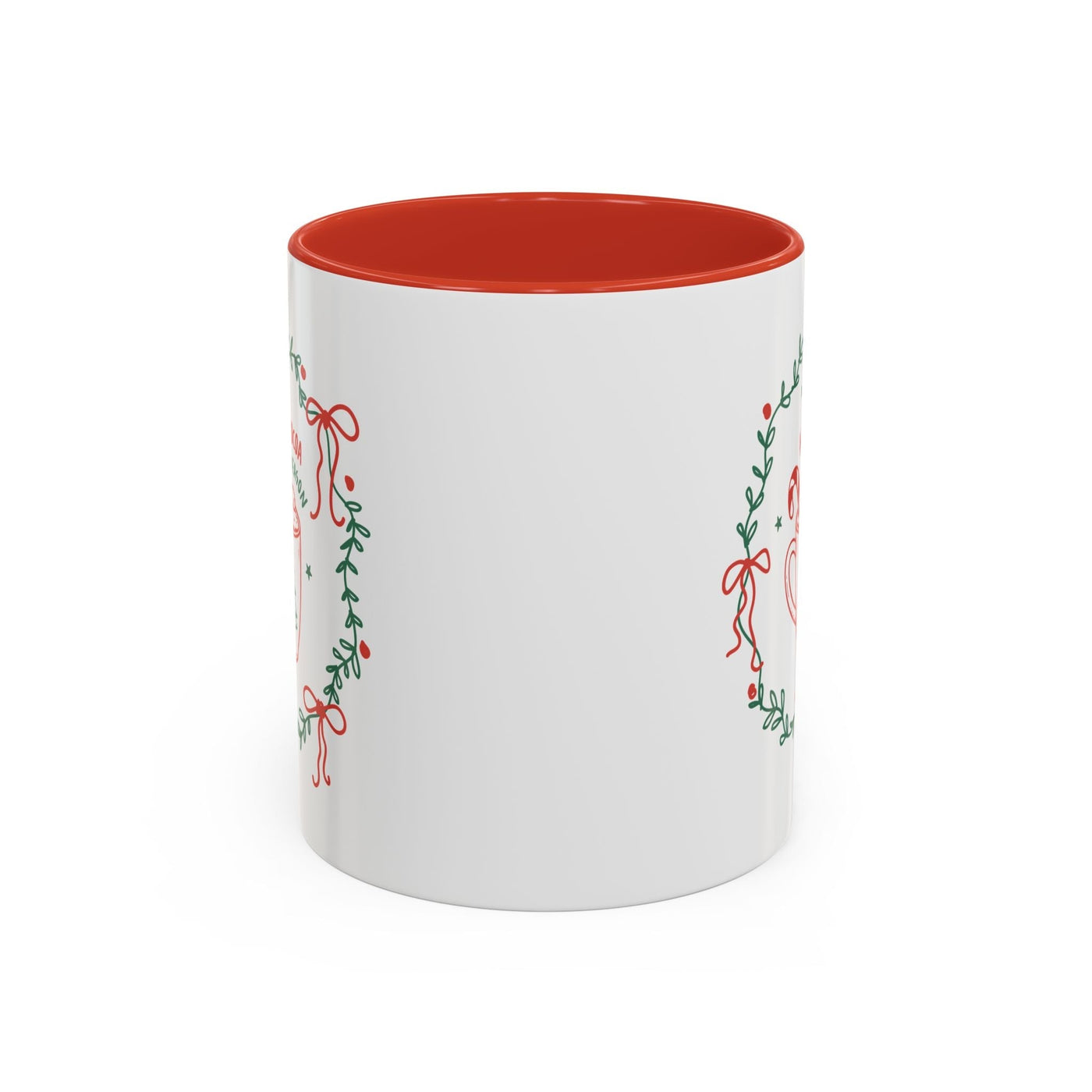 White ceramic mug with red interior and festive greenery design for hot cocoa season