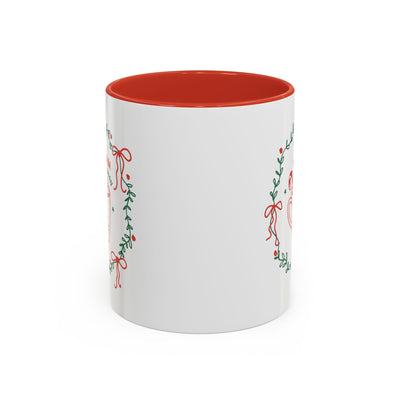White ceramic mug with red interior and festive greenery design for hot cocoa season