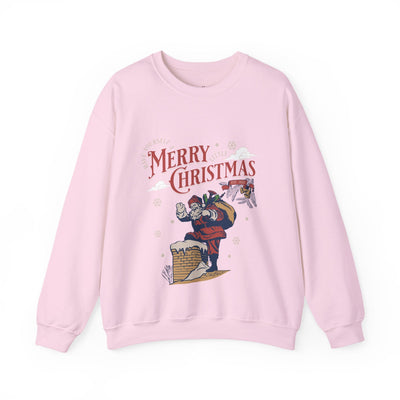 Pink vintage Santa crewneck sweatshirt with Santa carrying gift bag into chimney and "Merry Christmas" text design