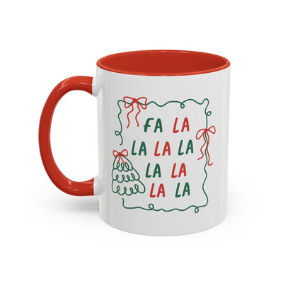 Fa La La Christmas coffee mug with red handle and rim, minimalist holiday design in red and green on white ceramic