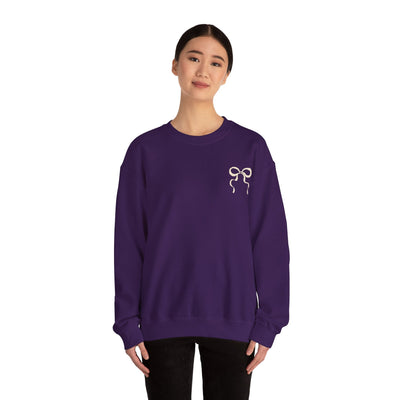 Woman wearing purple Coquette Christmas Faith crewneck sweatshirt with coquette bow design