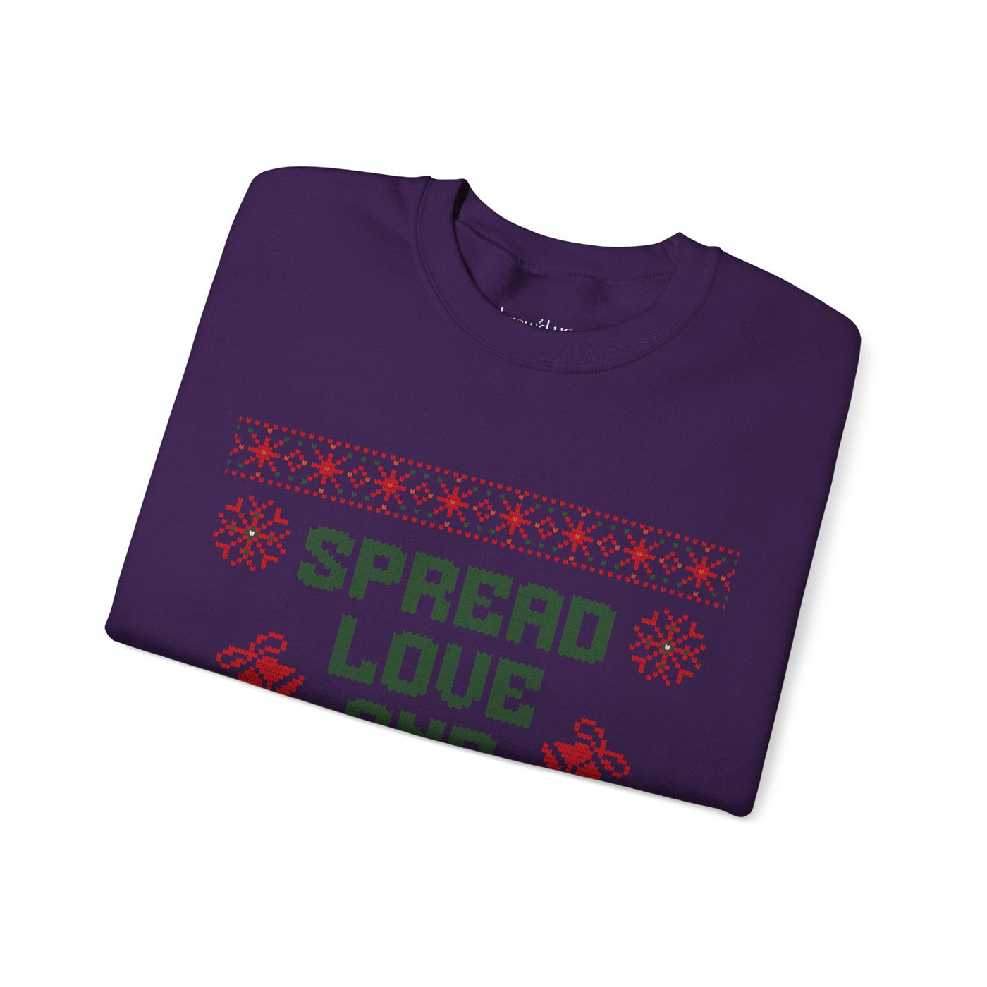 Folded cozy purple crewneck sweatshirt with "Spread Love and Christmas Cheer" holiday design