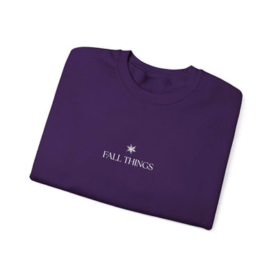 Folded purple Fall Things Sweatshirt with minimalist white text and star design, cozy cotton-poly blend autumn crewneck for coffee lovers and homebodies