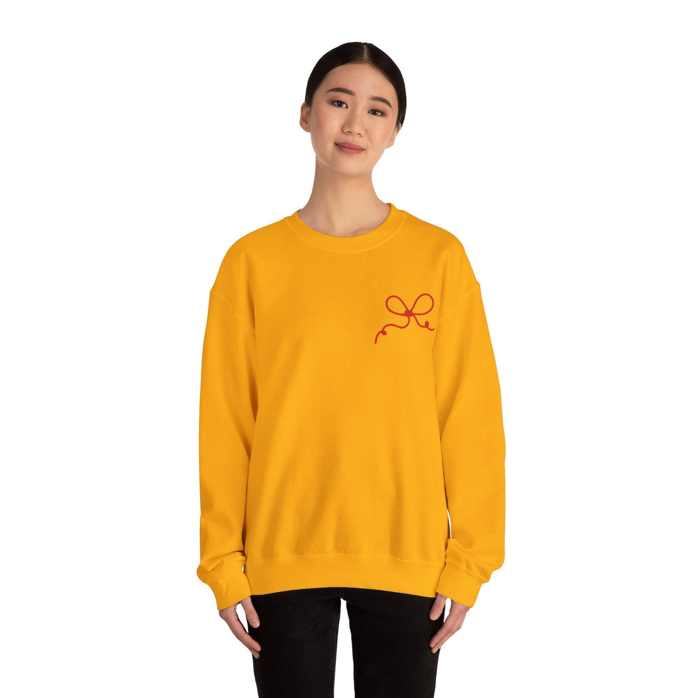 yellow Coquette Bow Crewneck Sweatshirt with red bow detail on front worn by woman