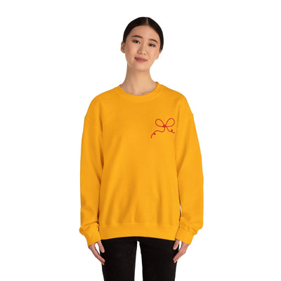 yellow Coquette Bow Crewneck Sweatshirt with red bow detail on front worn by woman
