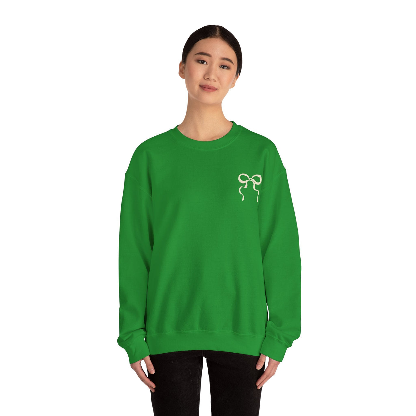 Woman wearing green Coquette Christmas Faith crewneck sweatshirt with a coquette bow design on the front.