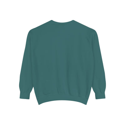 Cozy unisex garment-dyed sweatshirt in teal with minimalist embroidery, ribbed collar and cuffs, made of soft cotton-polyester blend.