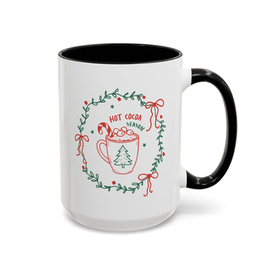 White ceramic mug with black handle and festive hot cocoa season design