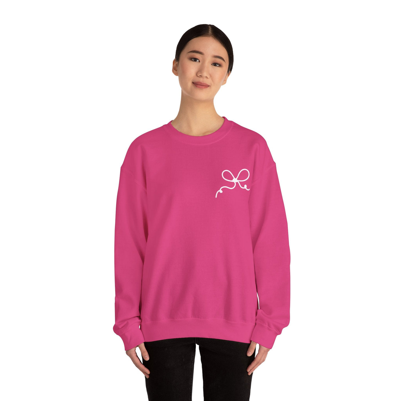Pink Coquette Bow Crewneck Sweatshirt with white bow design on front worn by woman