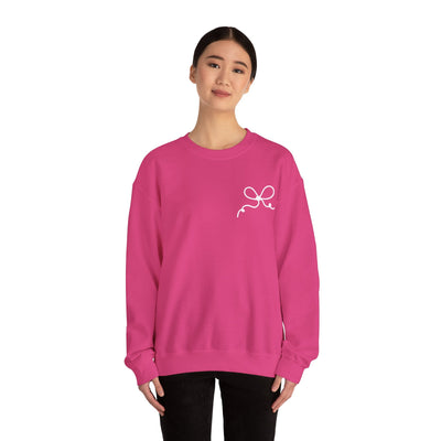 Pink Coquette Bow Crewneck Sweatshirt with white bow design on front worn by woman