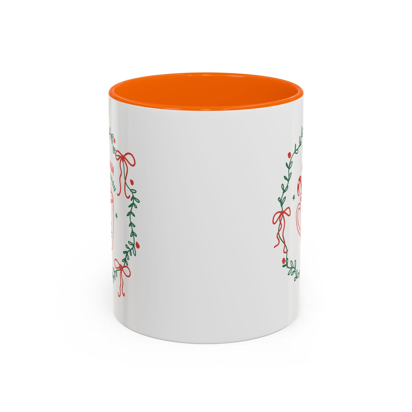 white ceramic mug with red interior and green wreath design for hot cocoa season
