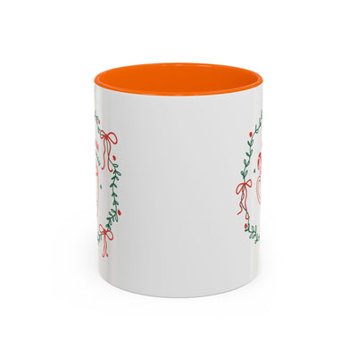 white ceramic mug with red interior and green wreath design for hot cocoa season