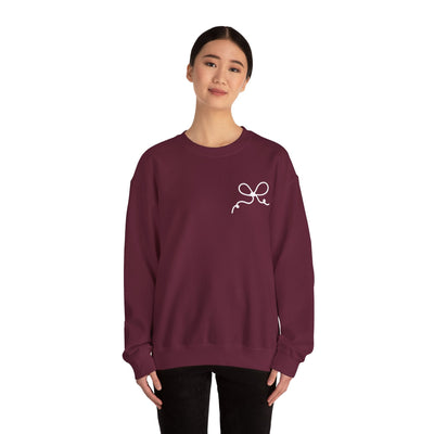 Woman wearing burgundy Coquette Bow Crewneck Sweatshirt with small bow design on chest
