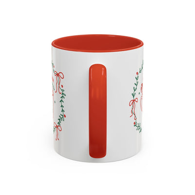 White ceramic mug with red interior and handle, festive greenery and bow design, available in 11oz and 15oz sizes