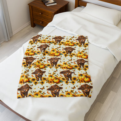 Cozy Highland Cow Velveteen Plush Blanket with pumpkins and sunflowers on bed for rustic farmhouse fall decor