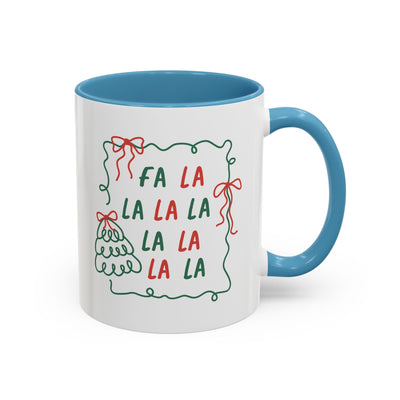 Fa La La Christmas Coffee Mug with blue handle and festive text design in red and green on white ceramic