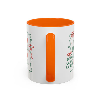 White ceramic Fa La La Christmas coffee mug with orange handle and interior, minimalist holiday design, microwave and dishwasher safe