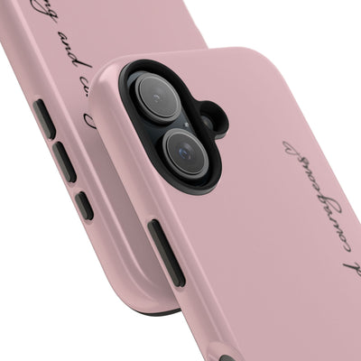 Close-up of pink inspirational tough phone case with "Be strong and courageous" text and dual-layer protection for iPhone and Samsung models