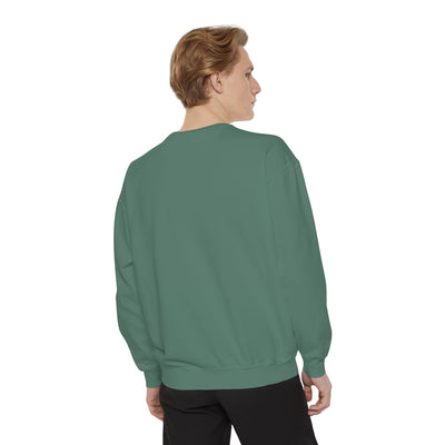Back view of a model wearing a cozy unisex garment-dyed sweatshirt with minimalist embroidery design in muted green color