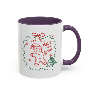 White ceramic festive Christmas coffee mug with purple handle and interior, featuring a gingerbread man and holiday tree design with "Made with Love" text