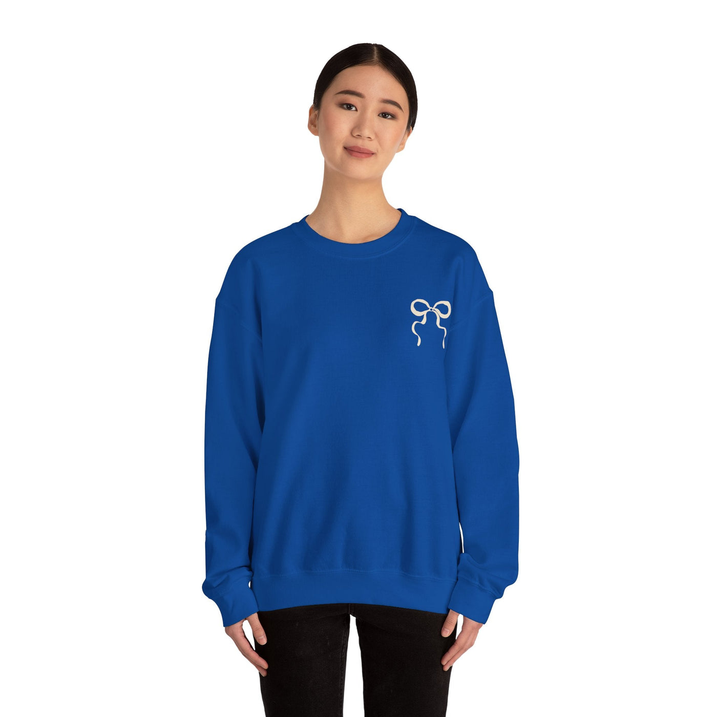 Woman wearing blue Coquette Christmas Faith Crewneck sweatshirt with bow design on front