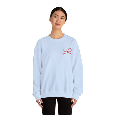 Woman wearing light blue Coquette Bow Crewneck Sweatshirt with red bow design on front