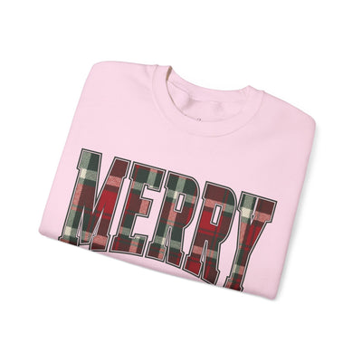 Folded pink crewneck sweatshirt with "MERRY" plaid Christmas graphic for festive holiday wear