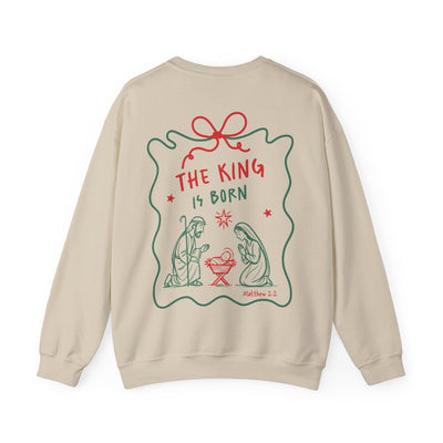 Coquette Bow Crewneck Sweatshirt with "The King is Born" nativity design in festive red and green on beige background