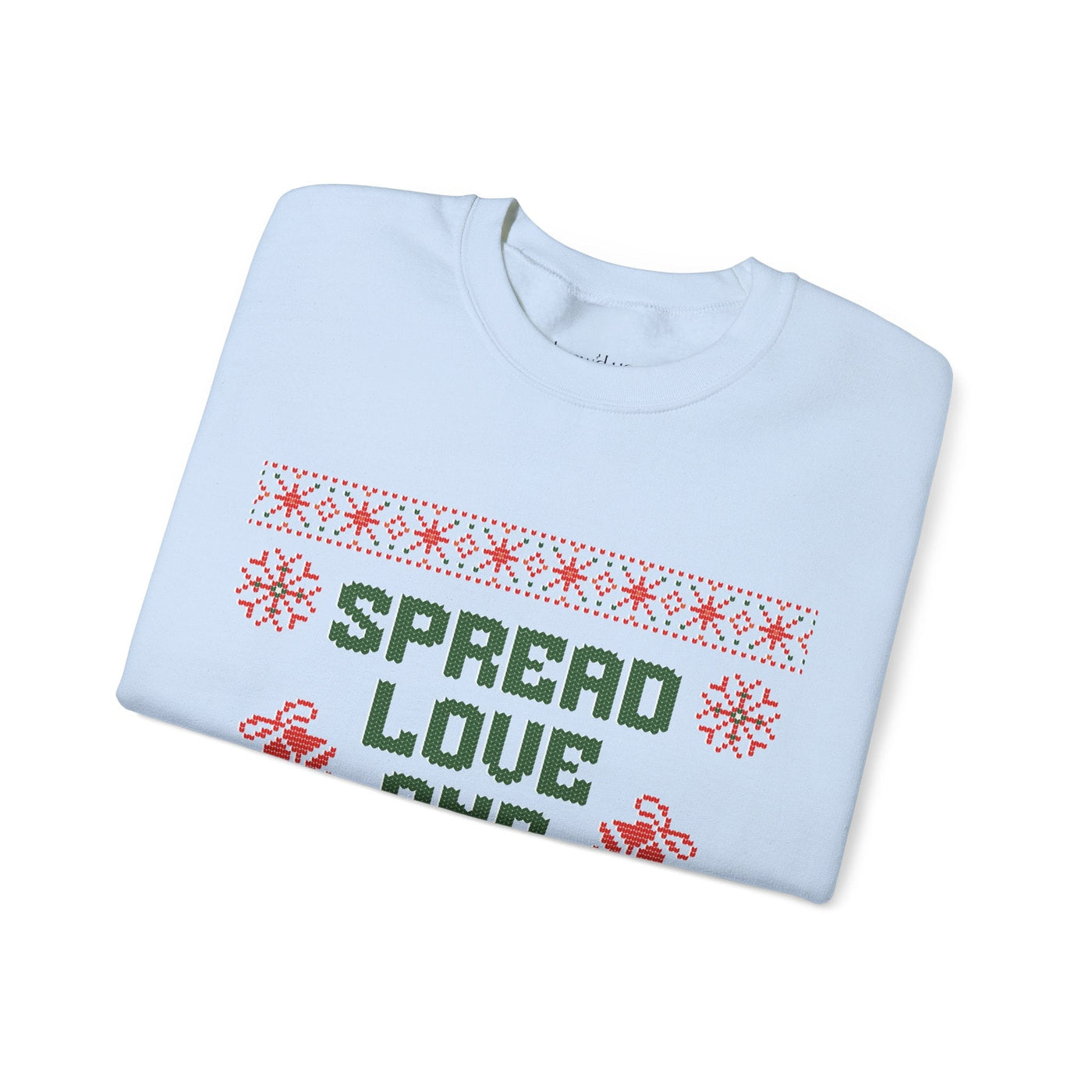 Folded white crewneck sweatshirt with "Spread Love and Christmas Cheer" holiday design in green and red