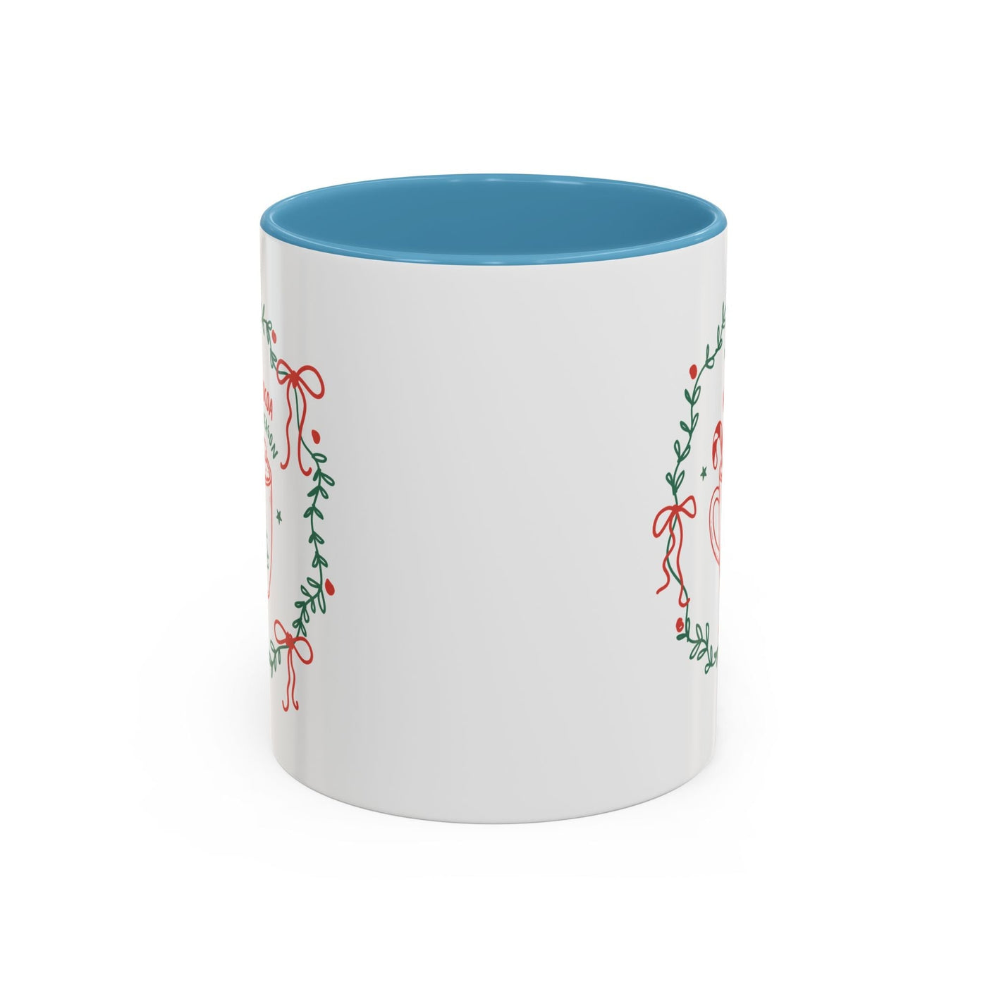 White ceramic mug with blue interior and decorative wreath design