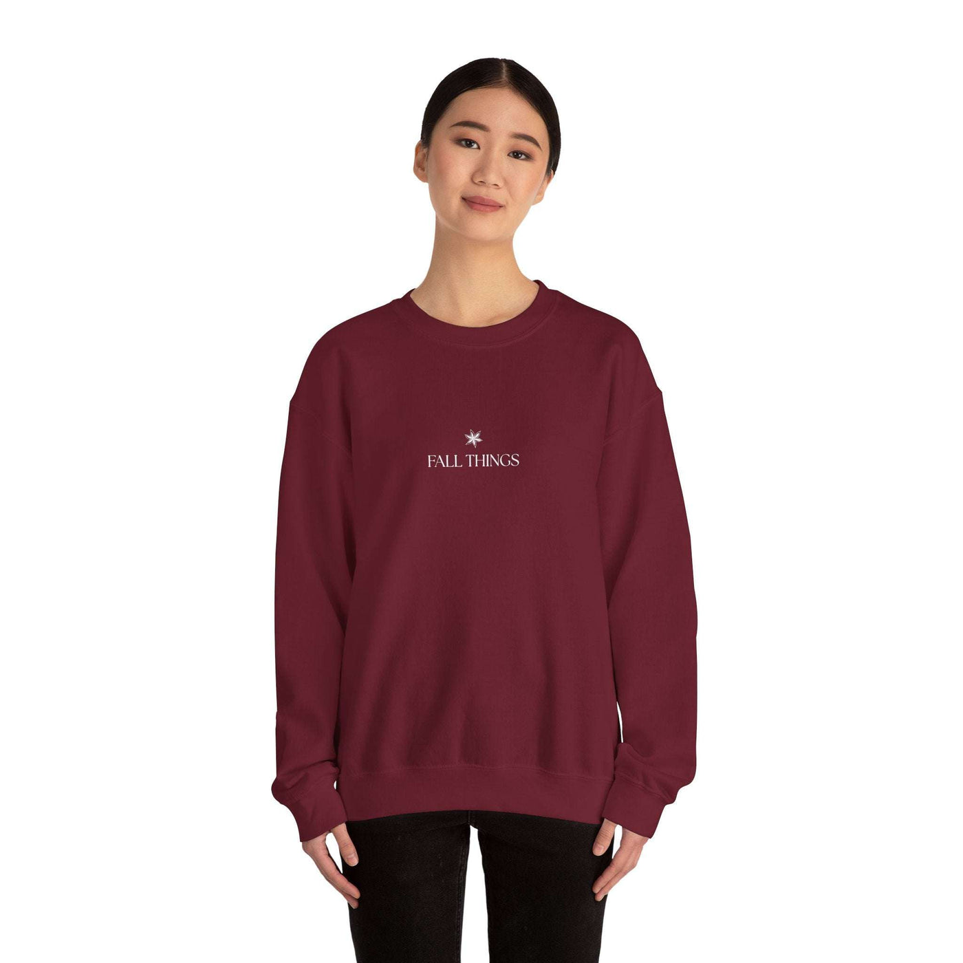 woman wearing burgundy Fall Things Sweatshirt with minimalist autumn design
