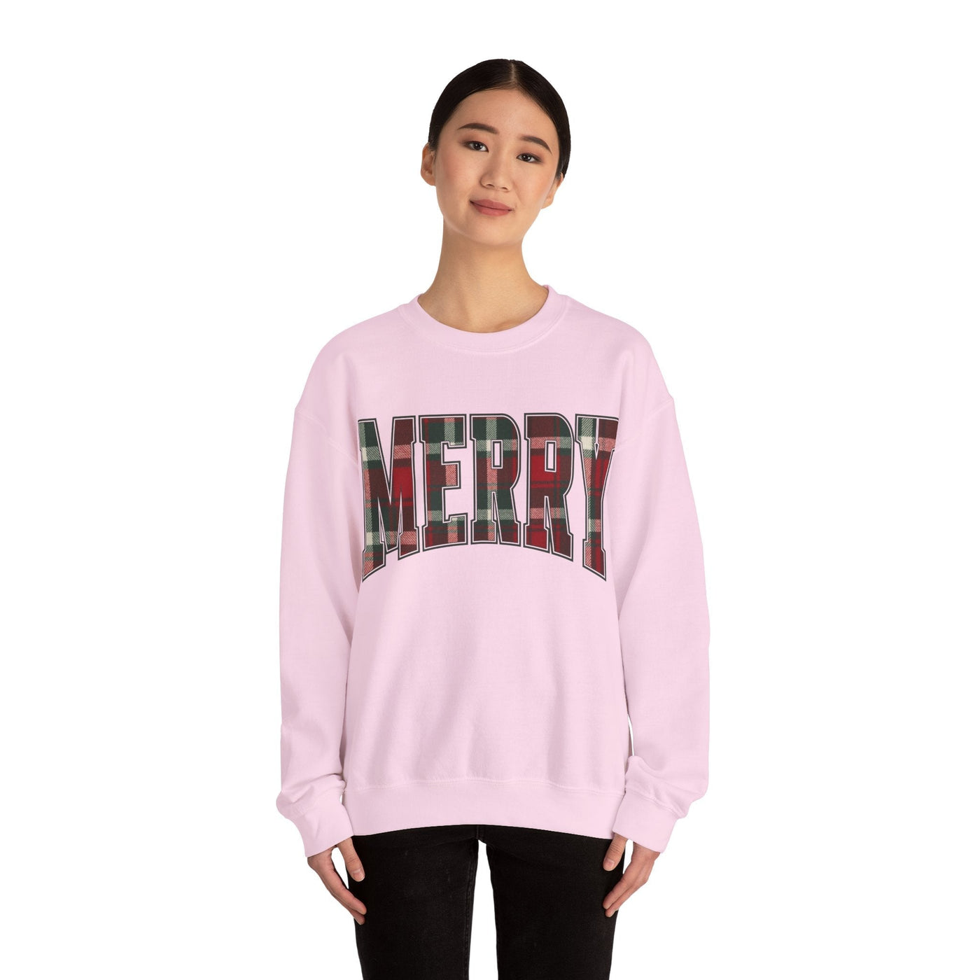 woman wearing pink crewneck sweatshirt with MERRY plaid Christmas graphic