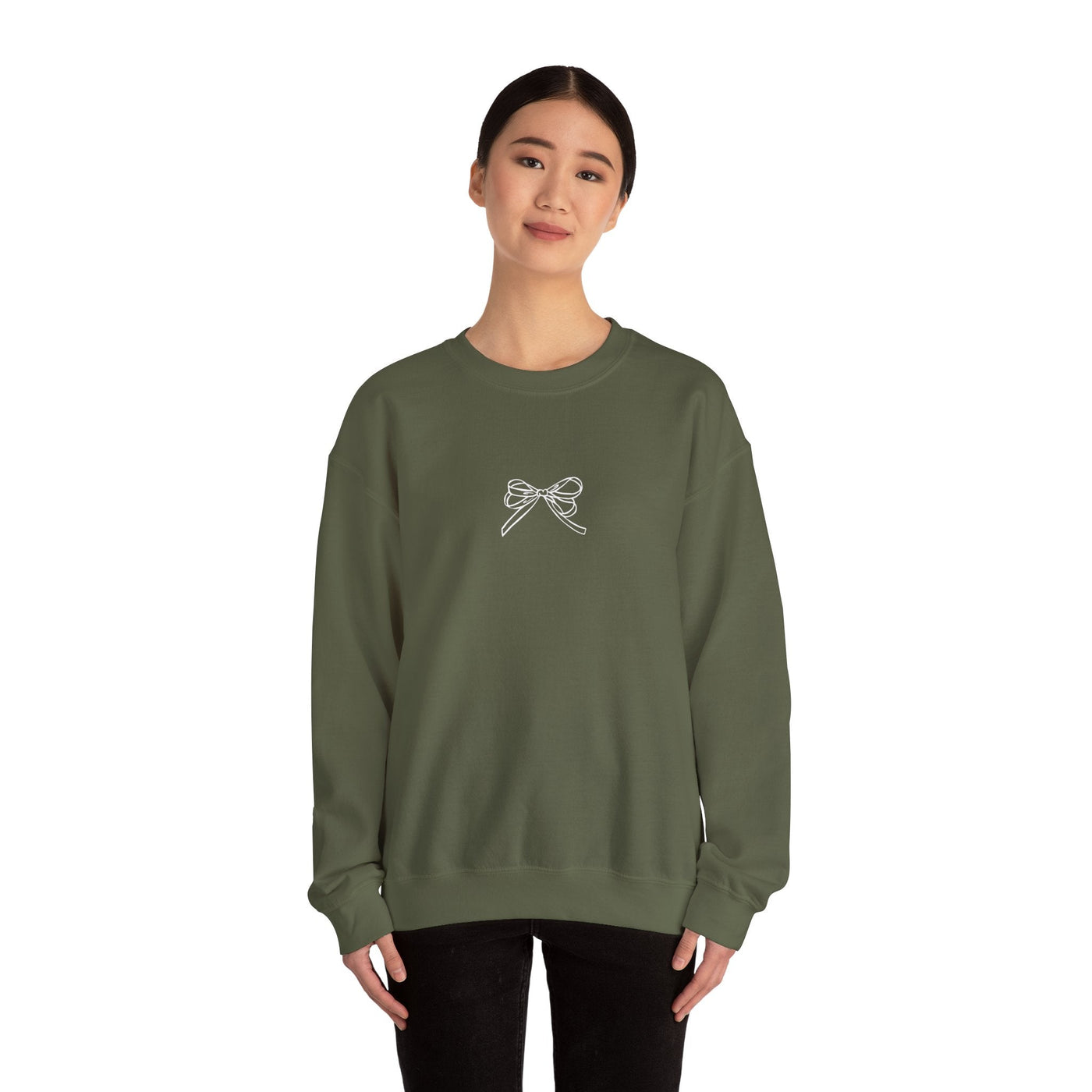 Olive green Holiday Bow Crewneck Sweatshirt with front bow design worn by a smiling woman