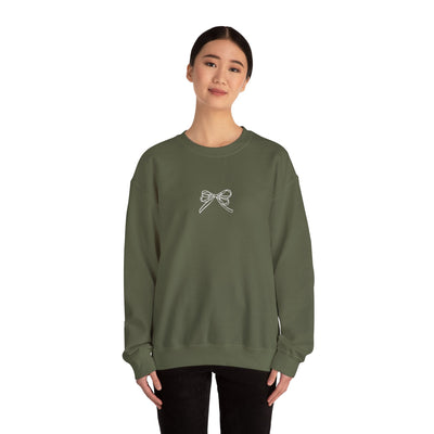 Olive green Holiday Bow Crewneck Sweatshirt with front bow design worn by a smiling woman