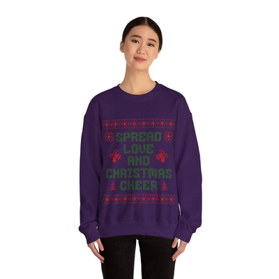 woman wearing cozy purple crewneck sweatshirt with Spread Love and Christmas Cheer holiday design