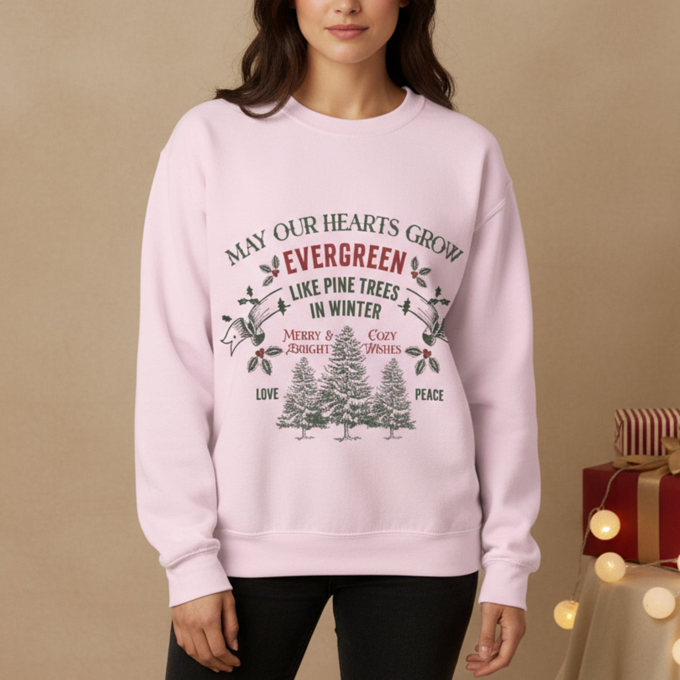 Unisex Christmas crewneck sweatshirt with evergreen tree holiday design and festive message in soft pink