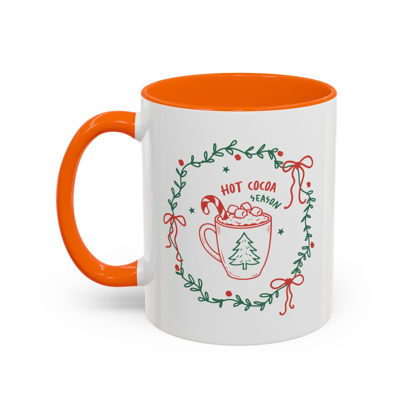 White ceramic mug with orange interior and handle, festive hot cocoa design with greenery wreath and red bows, microwave and dishwasher safe