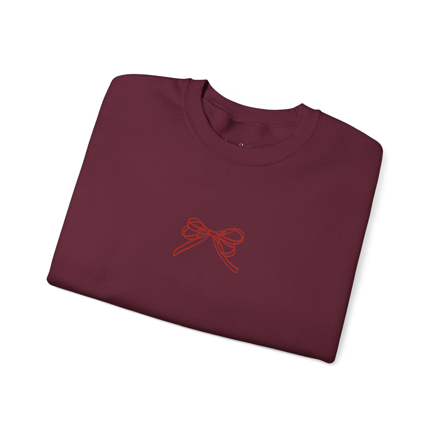 Folded maroon Holiday Bow Crewneck Sweatshirt with simple red bow design on front