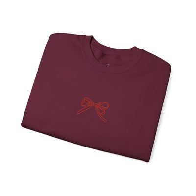 Folded maroon Holiday Bow Crewneck Sweatshirt with simple red bow design on front
