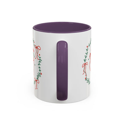 White ceramic mug with purple handle and interior, festive holiday greenery and bow design, available in 11oz and 15oz sizes