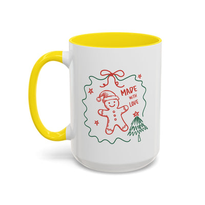 White ceramic festive Christmas coffee mug with yellow interior and handle, featuring a red and green "Made with Love" gingerbread design
