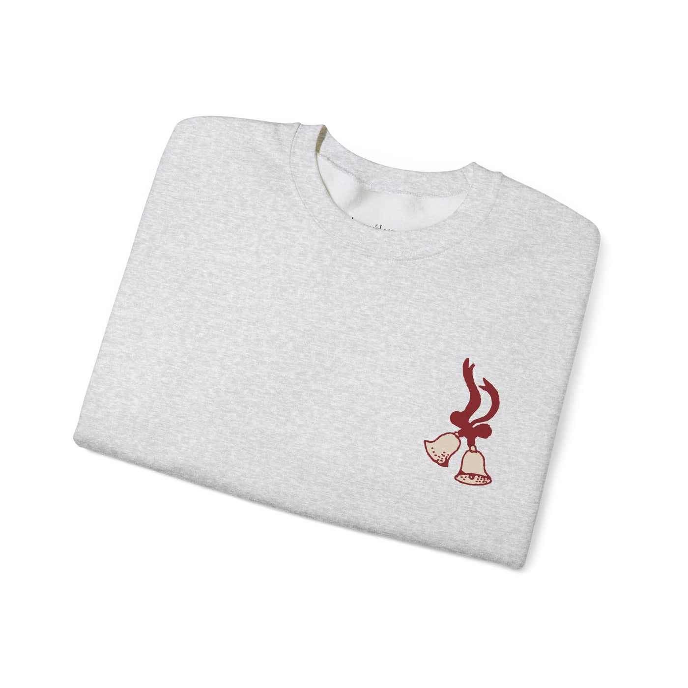 folded vintage Merry Christmas crewneck sweatshirt with bell and Santa sleigh design on light gray fabric
