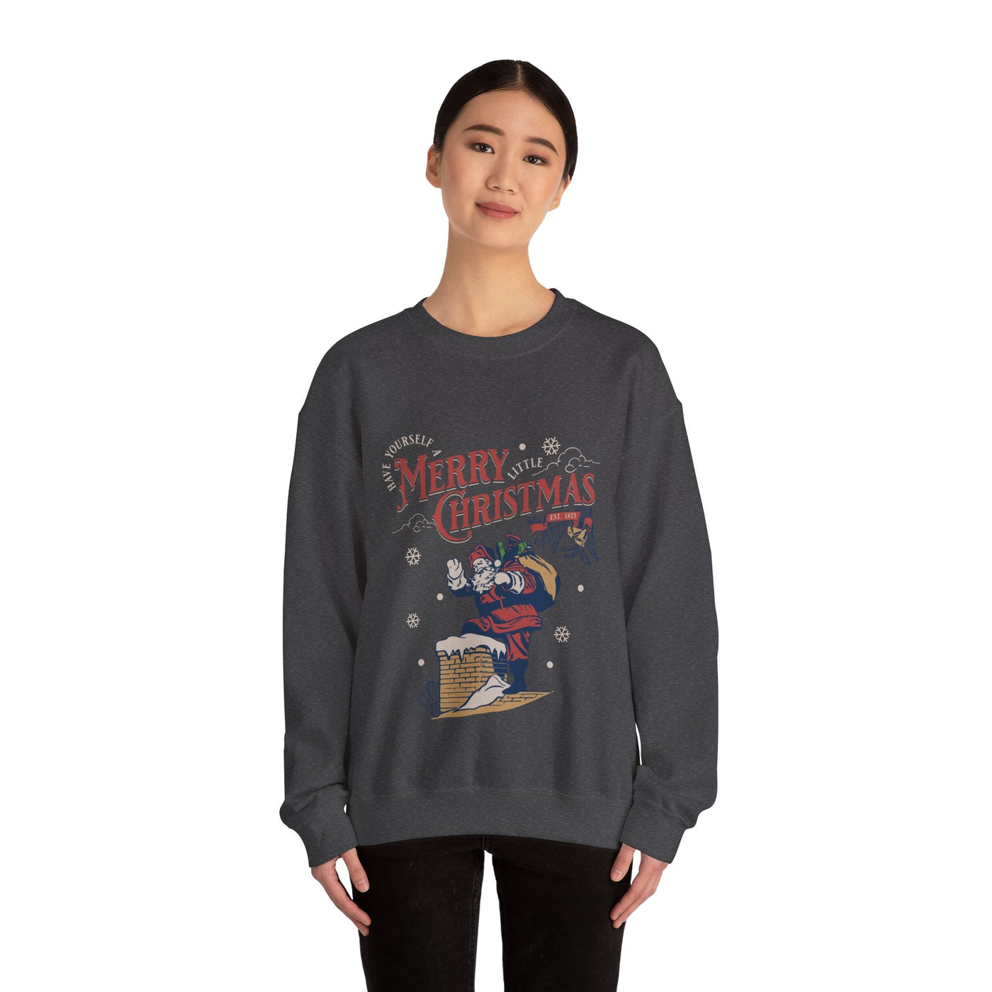 Woman wearing dark gray vintage Santa crewneck sweatshirt with Santa carrying gift bag going into chimney and Merry Christmas text