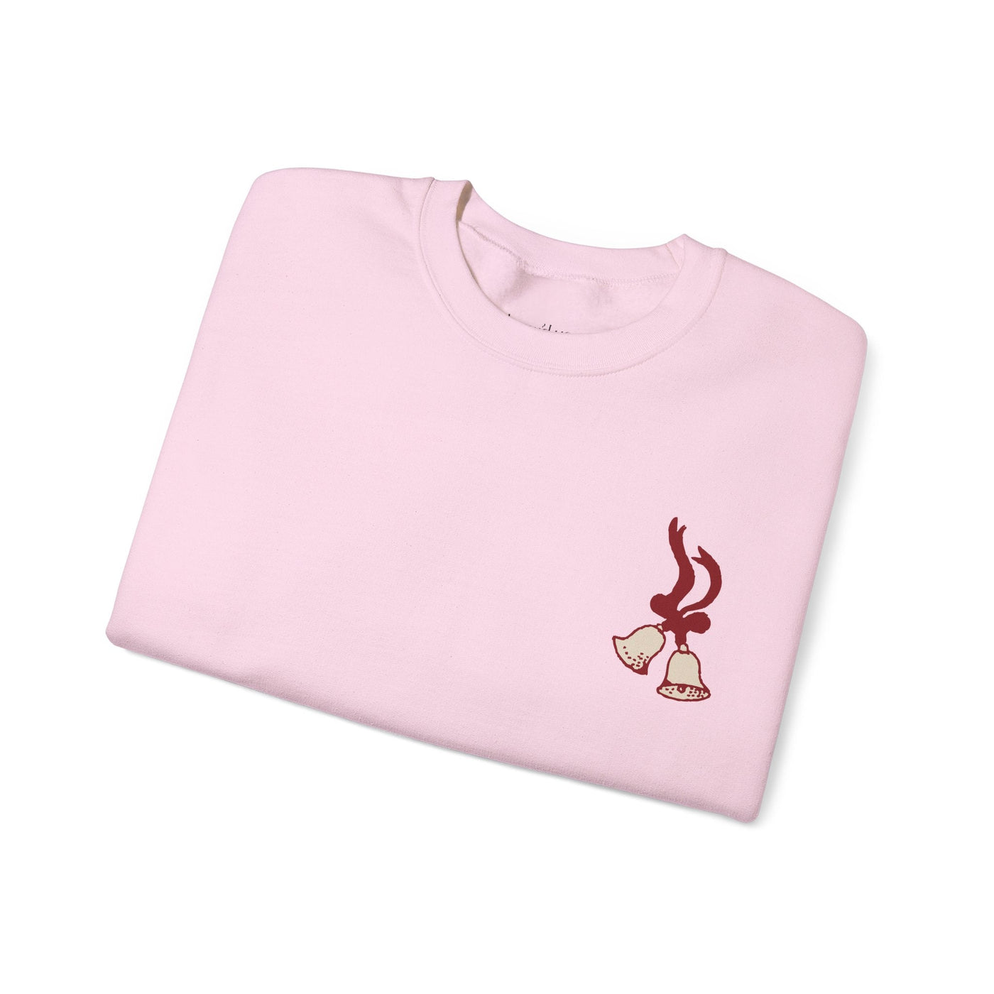 Folded pink vintage Merry Christmas crewneck sweatshirt with bell and Santa sleigh holiday design