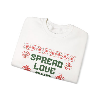 Folded white crewneck sweatshirt with red and green "Spread Love and Christmas Cheer" holiday design