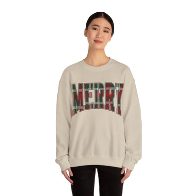 Woman wearing a beige crewneck sweatshirt with red and green plaid "MERRY" Christmas graphic